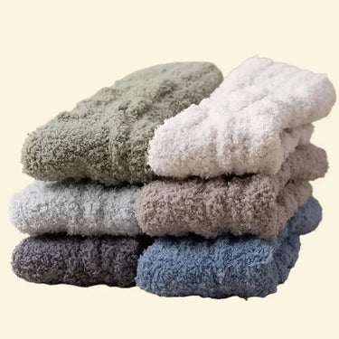 Stack of Warmweave™ Cozy Coral Velvet Socks in assorted winter colours including pine green, cream, grey, cocoa, charcoal, and frost blue – ultra‑soft coral velvet with non‑slip soles.